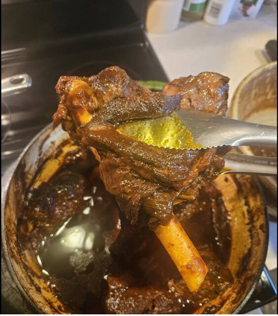 Braised shank held with tongs